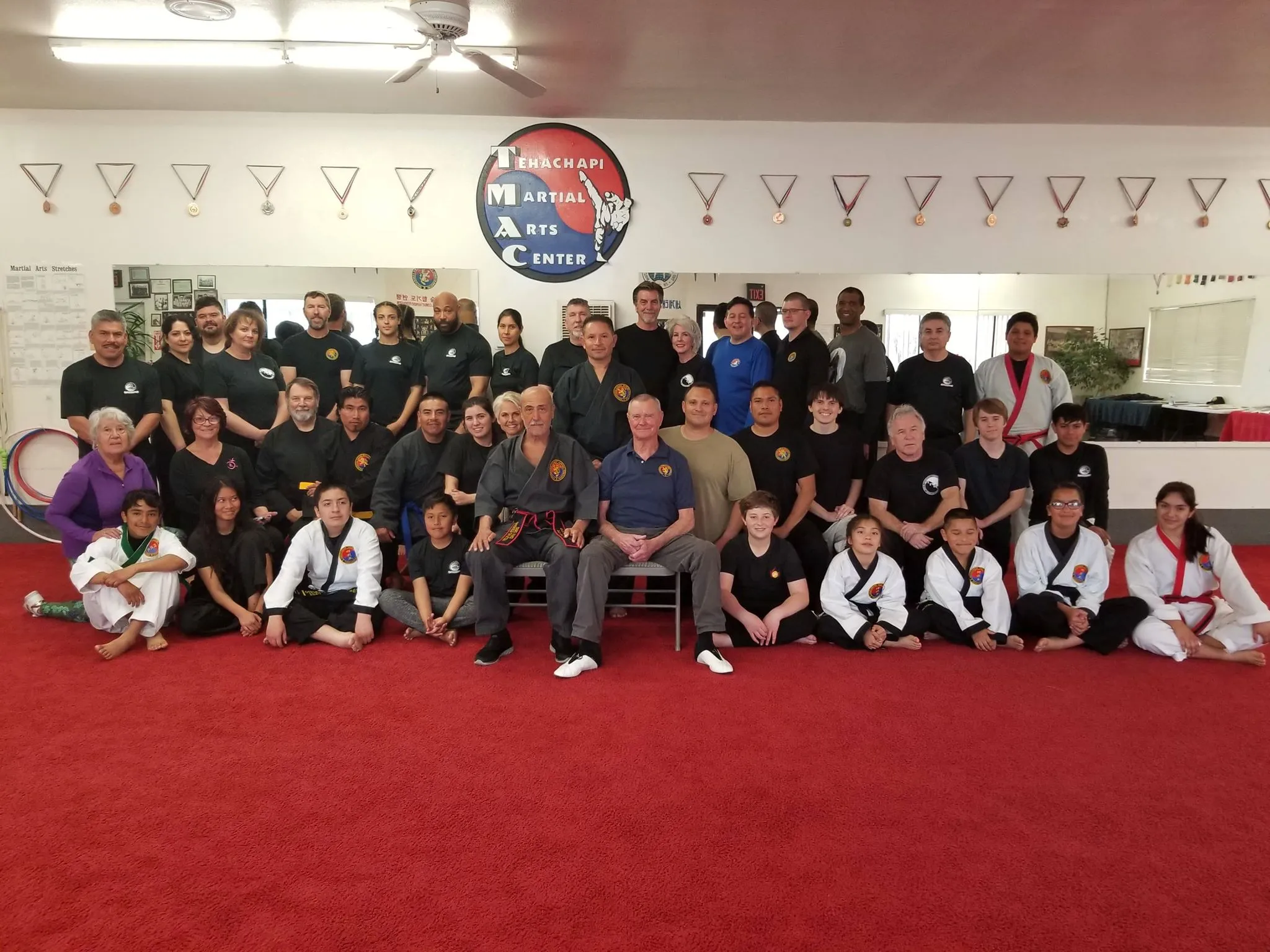 A large group of students and guests from the 2019 Combat Hapkido seminar, posing together on the red training mat.