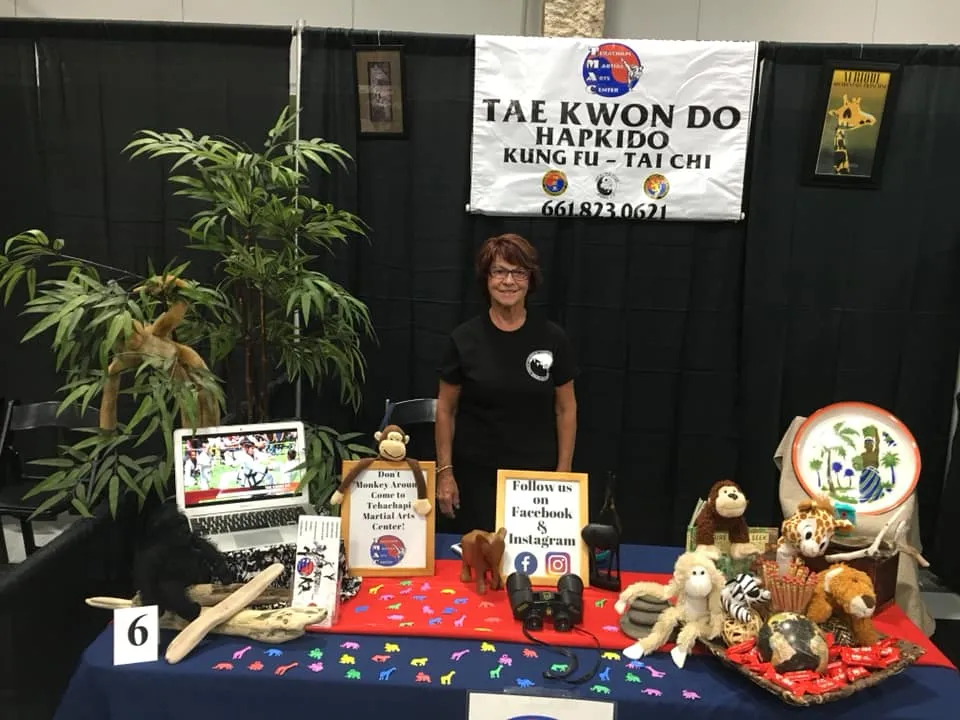 The TMAC table at the Fall Business Showcase, decorated with stuffed animals for the September Safari theme.